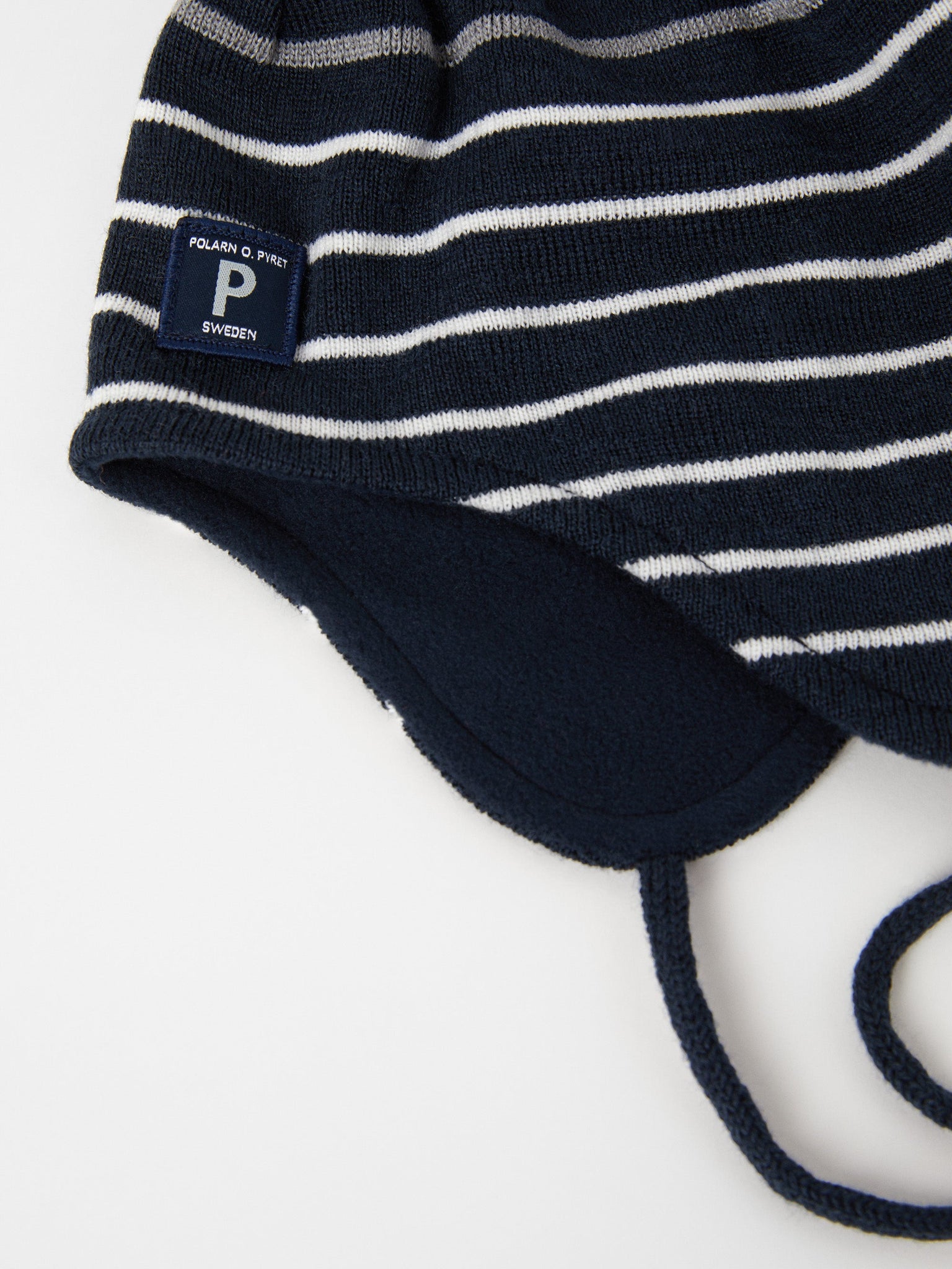 Merino Wool Navy Kids Bobble Hat from the Polarn O. Pyret outerwear collection. Ethically produced kids outerwear.