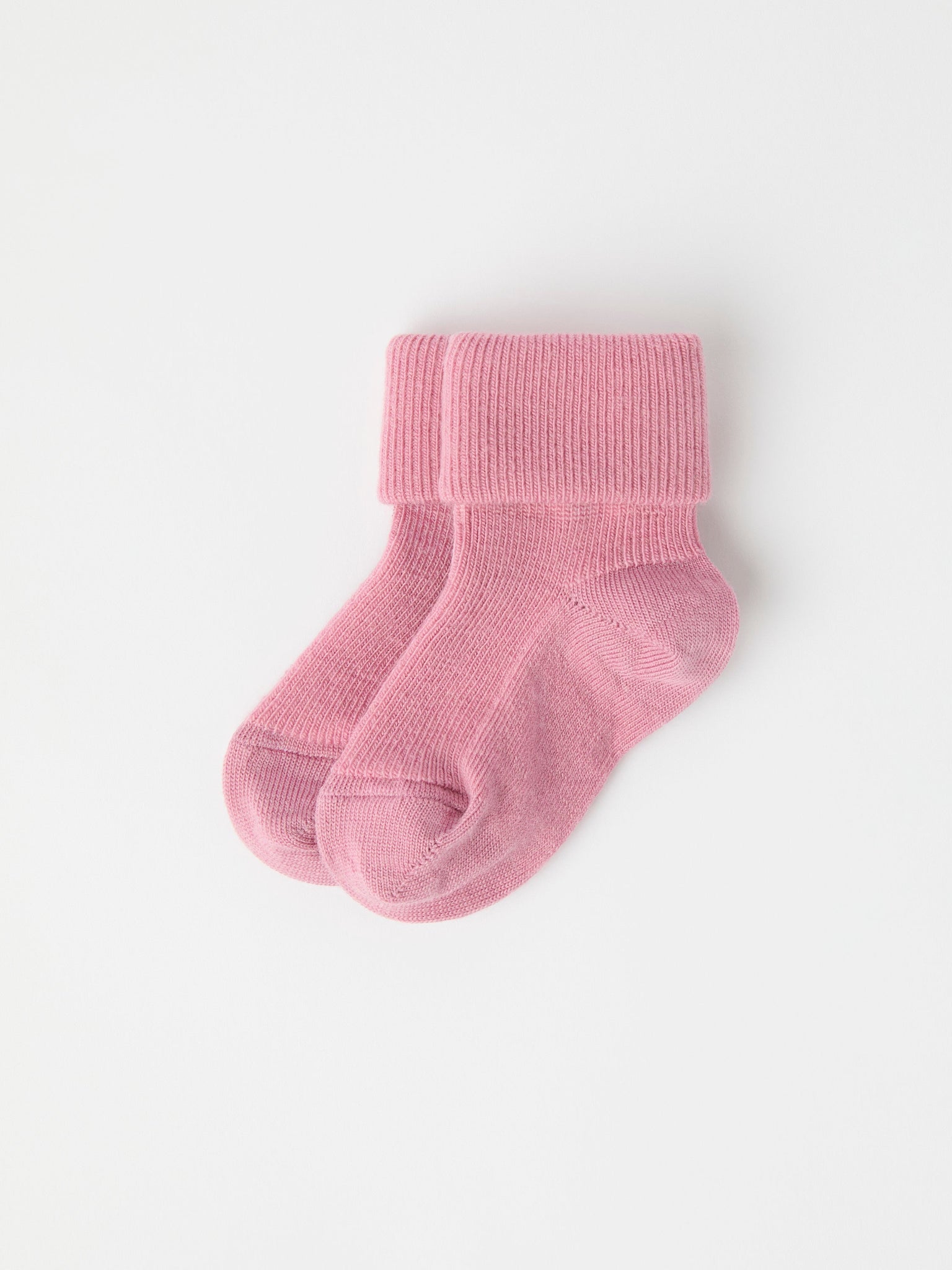 Pink Merino Baby Socks from the Polarn O. Pyret baby collection. Clothes made using sustainably sourced materials.