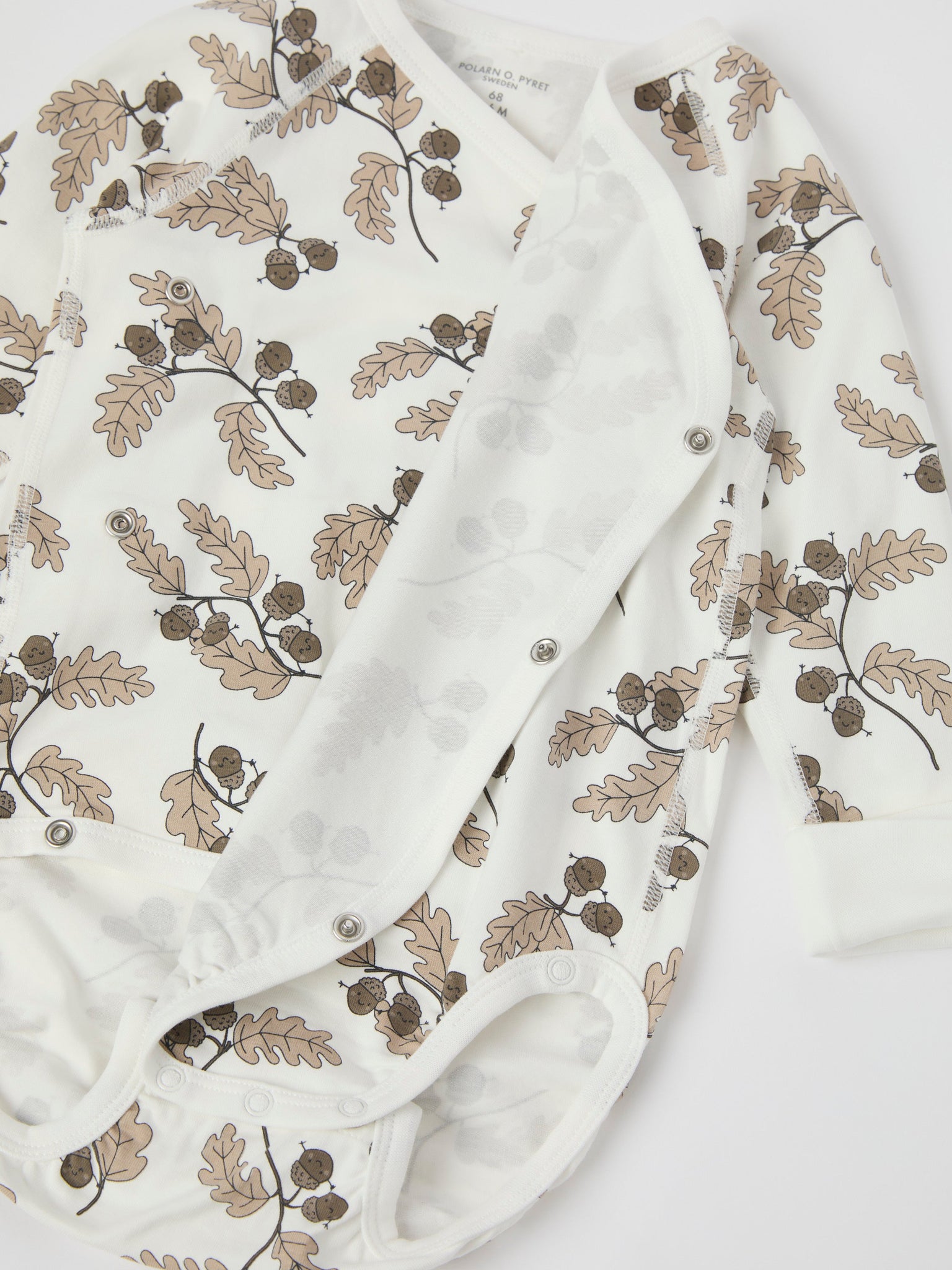 Acorn Print Wraparound Babygrow from the Polarn O. Pyret baby collection. Nordic kids clothes made from sustainable sources.