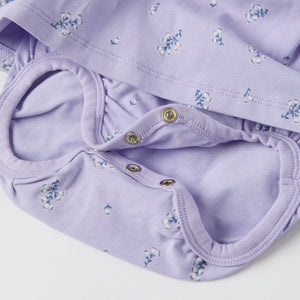 Purple Floral Print Babygrow Dress from the Polarn O. Pyret baby collection. Ethically produced kids clothing.