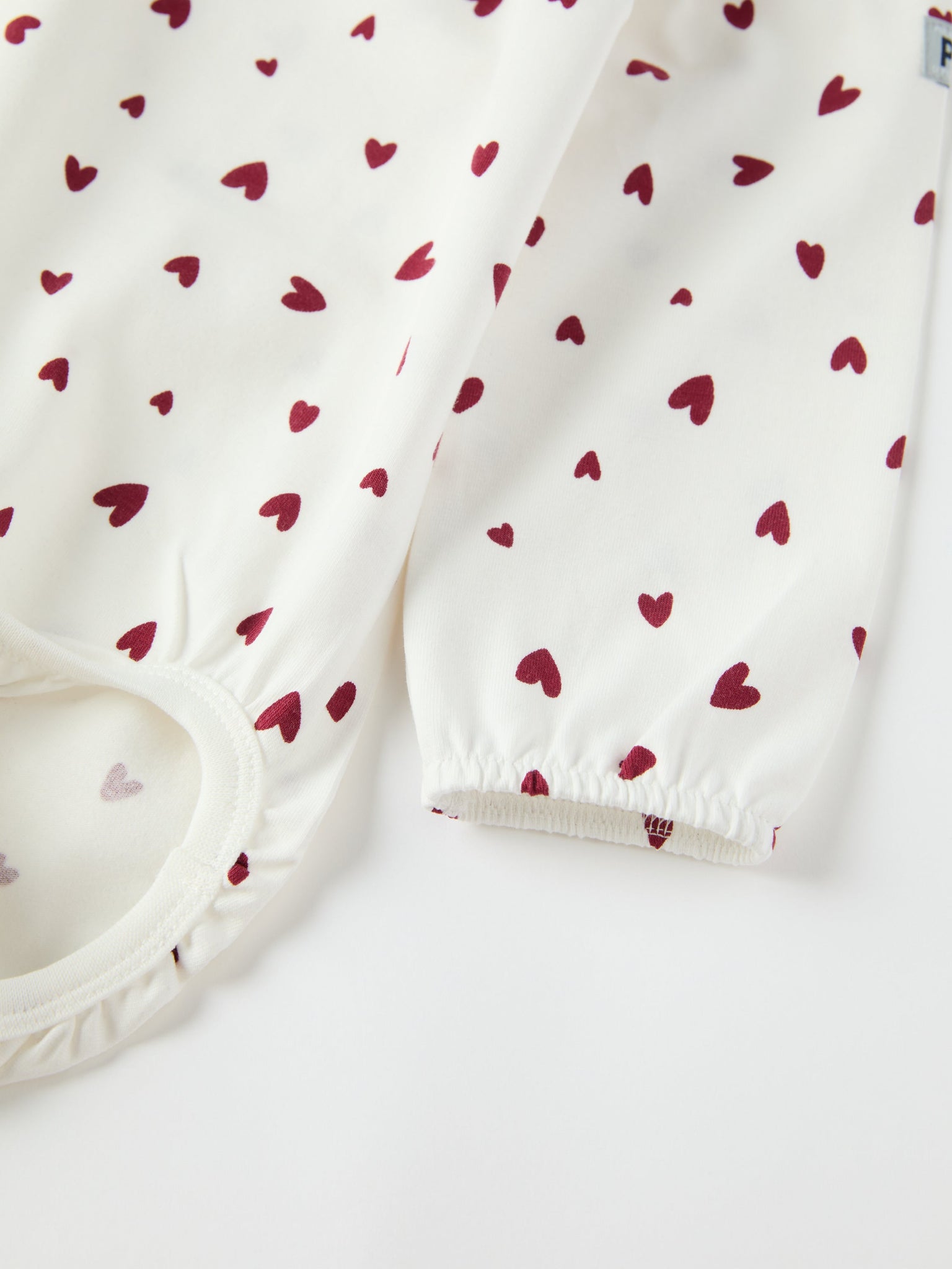 Organic Cotton Heart Print Babygrow from the Polarn O. Pyret baby collection. Ethically produced kids clothing.