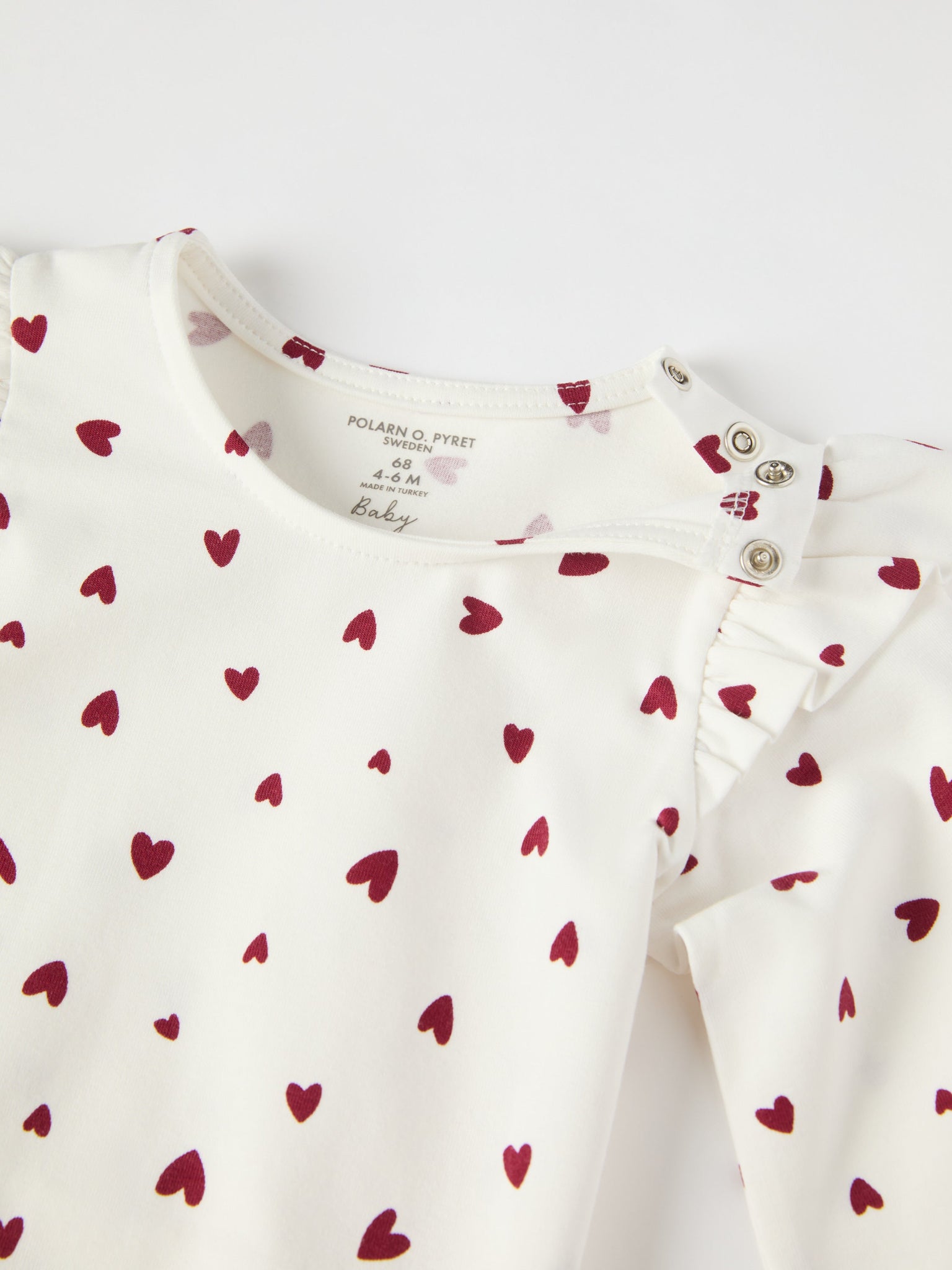 Organic Cotton Heart Print Babygrow from the Polarn O. Pyret baby collection. Ethically produced kids clothing.