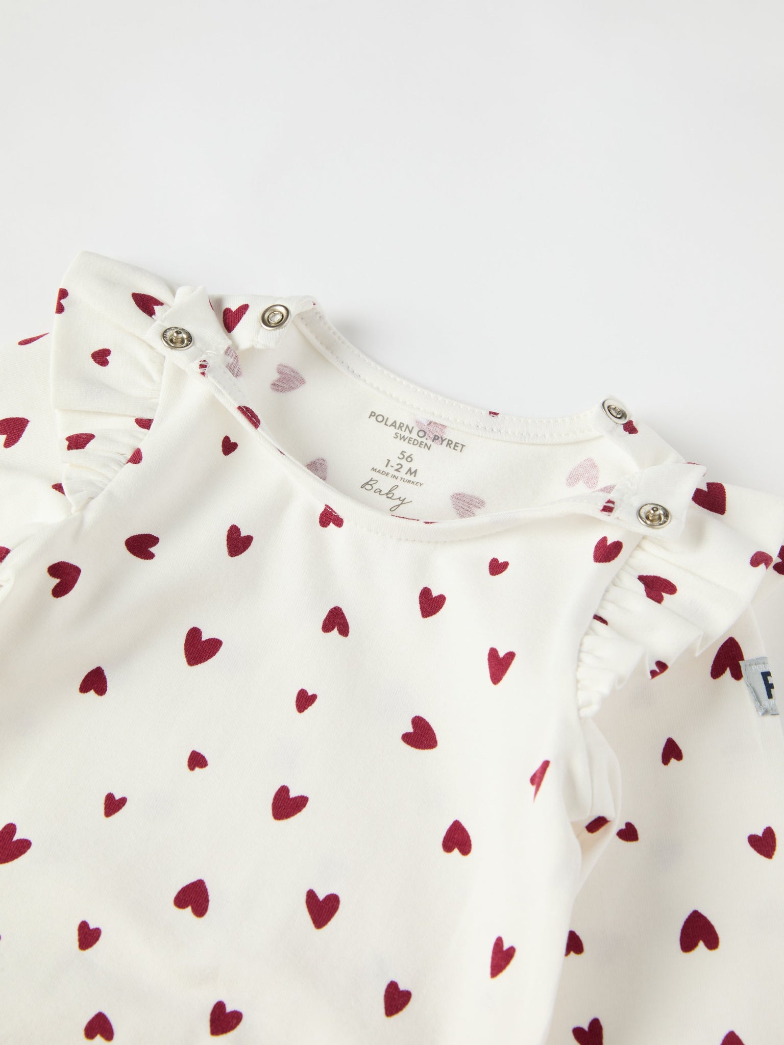 Organic Cotton Heart Print Babygrow from the Polarn O. Pyret baby collection. Ethically produced kids clothing.