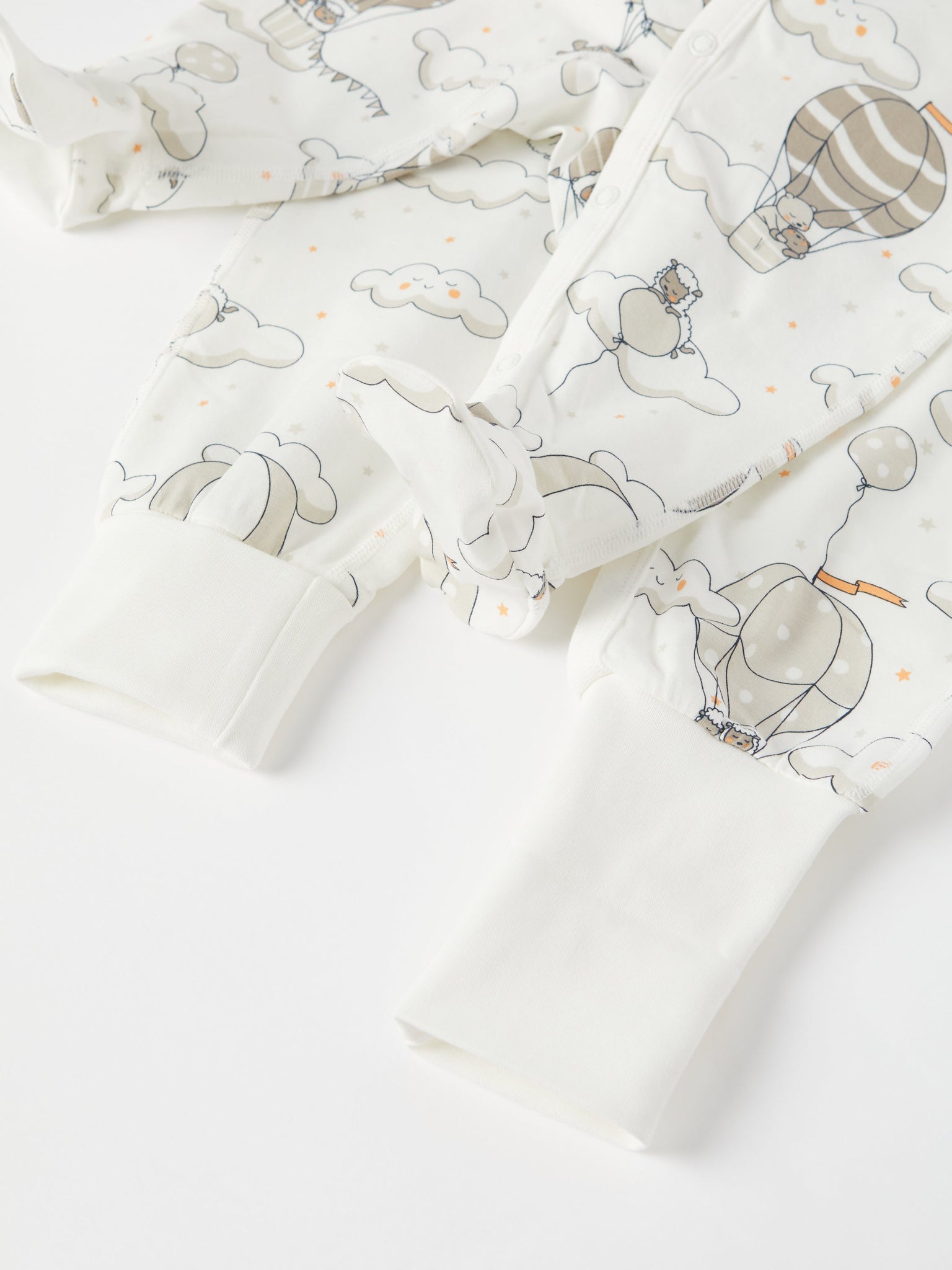 Balloon Print Baby Sleepsuit from the Polarn O. Pyret baby collection. Clothes made using sustainably sourced materials.