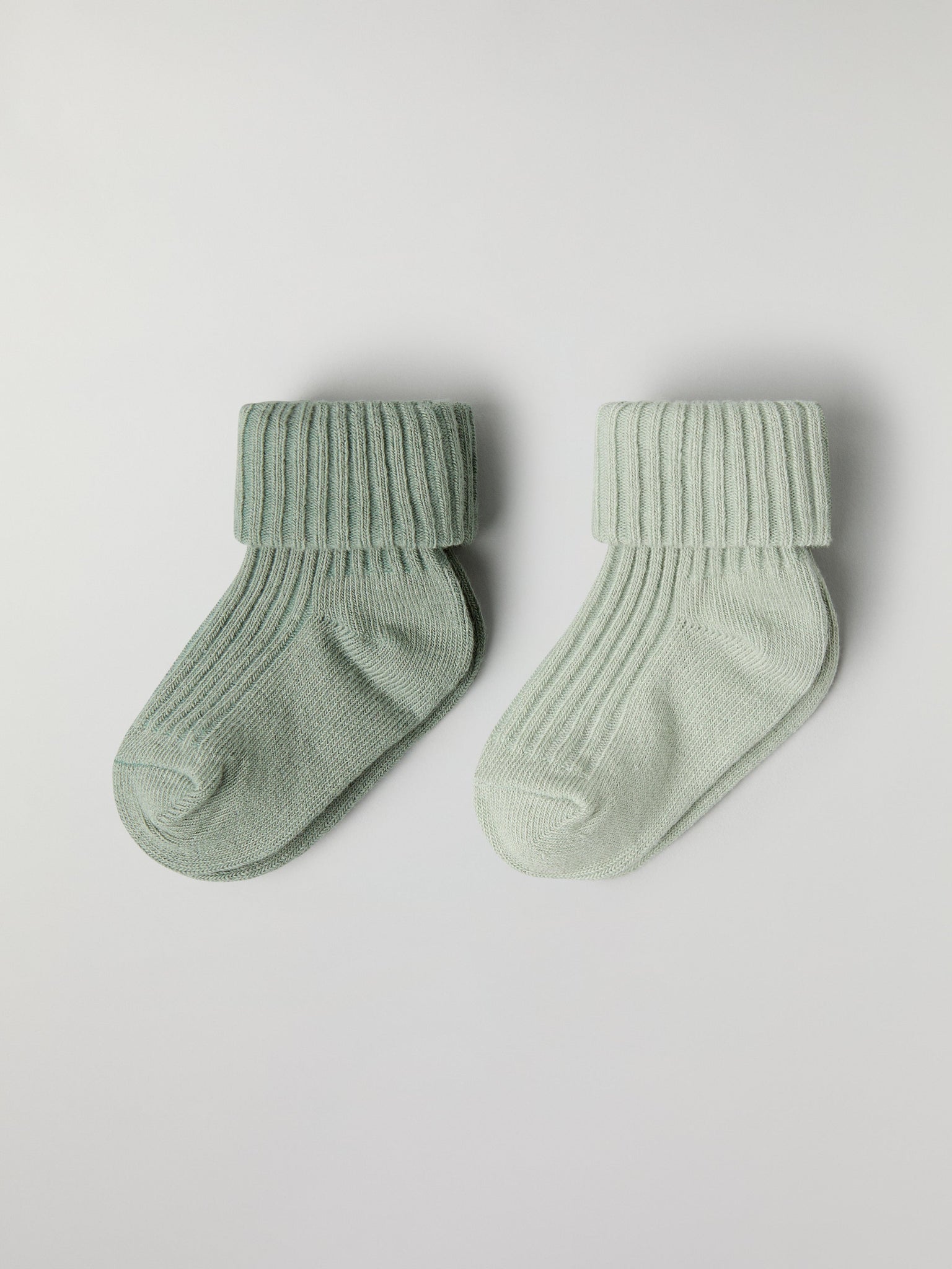 Two Pack Baby Socks in green from the Polarn O. Pyret baby collection. Clothes made using sustainably sourced materials.