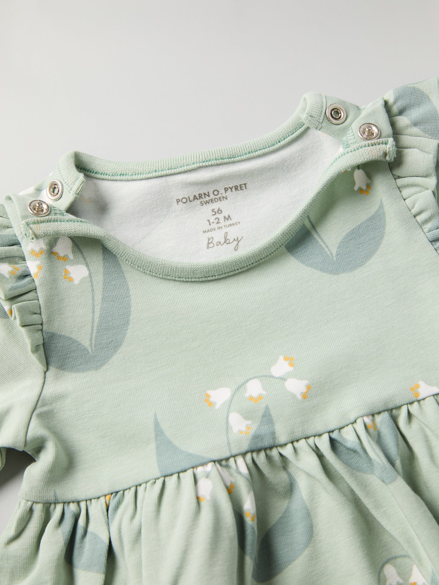 Lily Print Baby Dress from the Polarn O. Pyret baby collection. Clothes made using sustainably sourced materials.