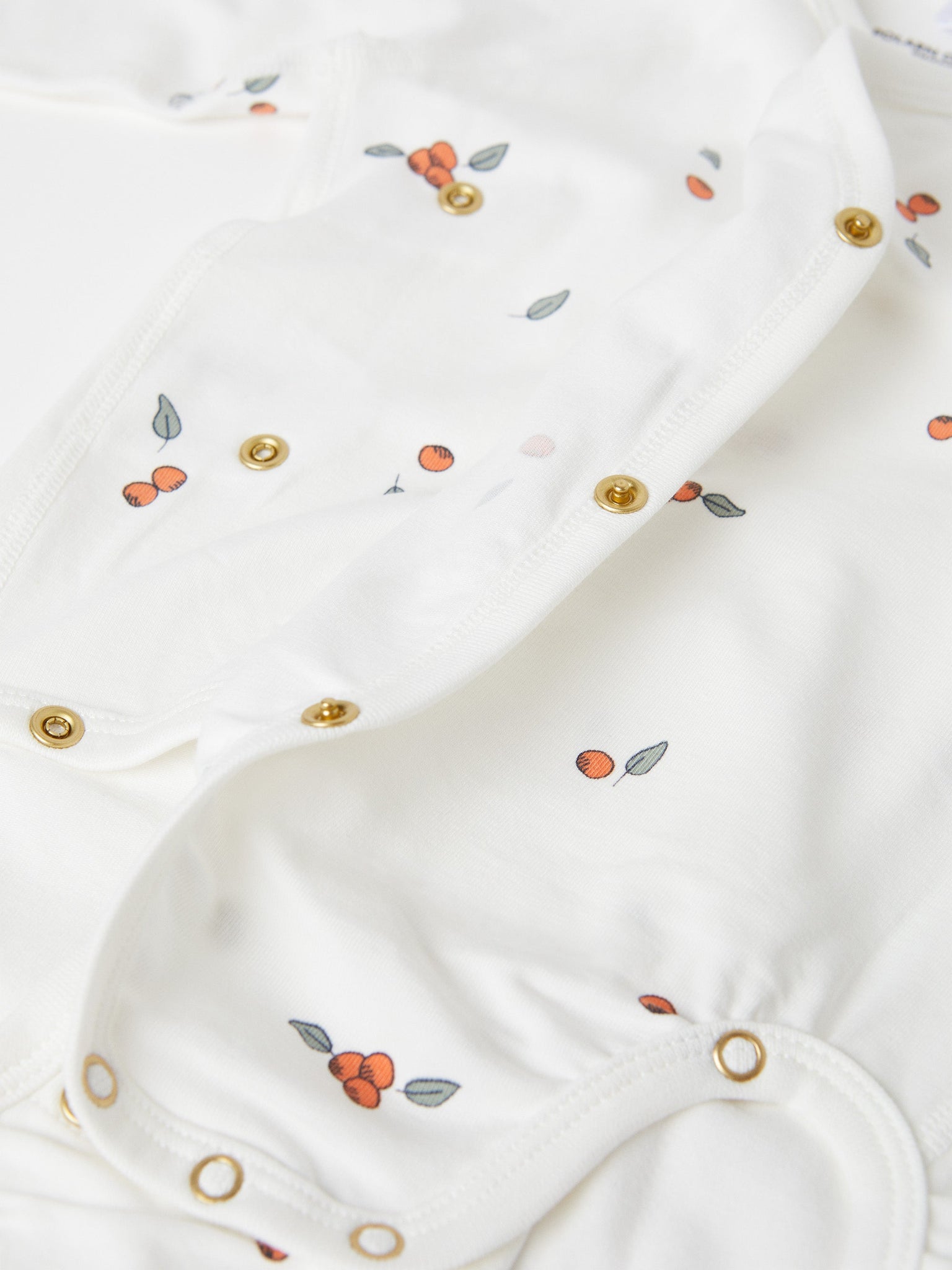 Organic Cotton White Wraparound Babygrow from the Polarn O. Pyret baby collection. Clothes made using sustainably sourced materials.